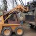Irish Hills resident Tom Hines, left, moves heavy tree stumps and roots on March 31, 2012, into a flatbed truck on the property of the Fike family. Angela J. Cesere | AnnArbor.com

